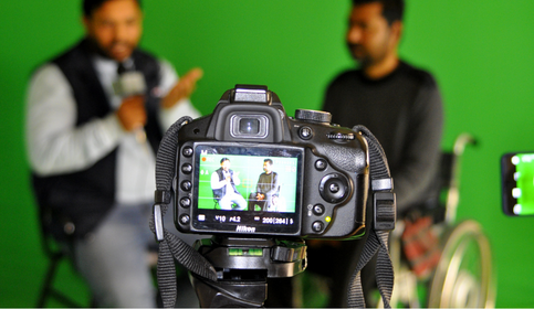 Skills and training Camera filming two people. The camera is in focus the people in the background are out of focus