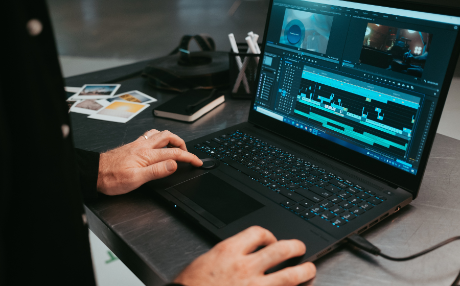Someone working at a laptop editing video,