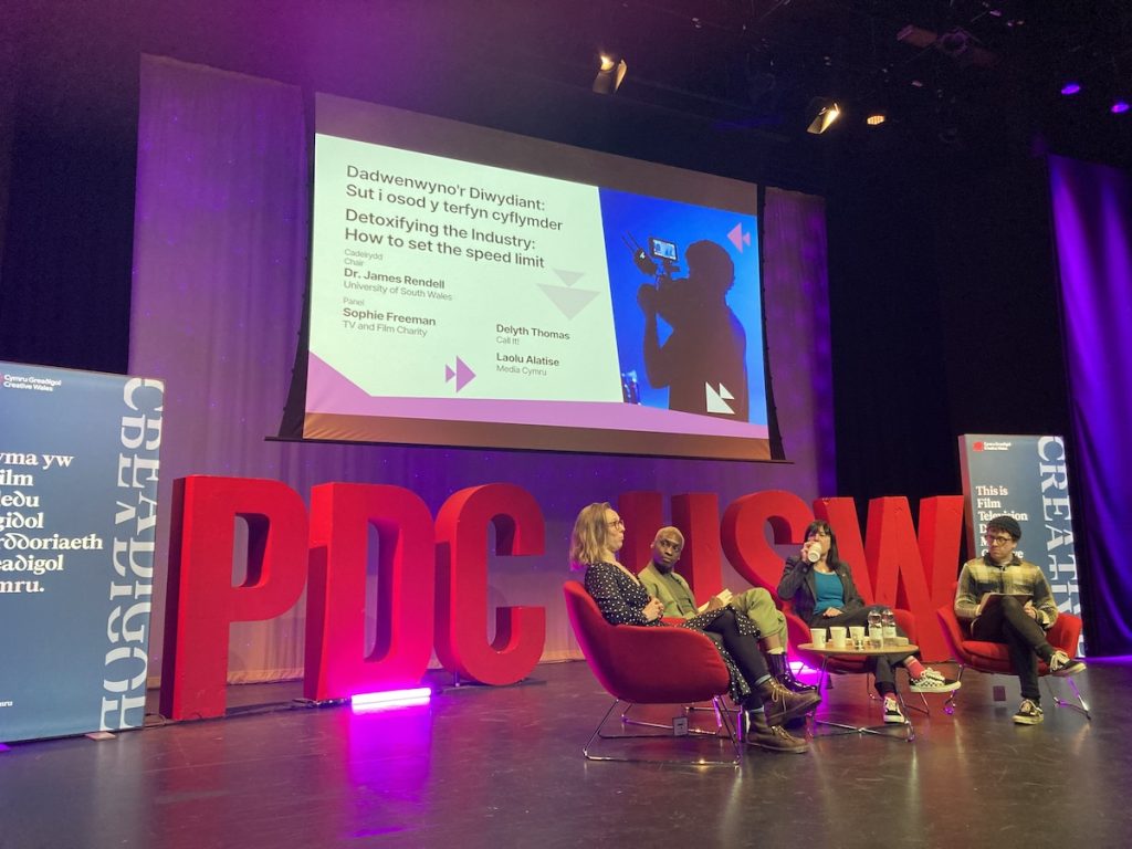 Laolu speaking on a panel at the University of South Wales.