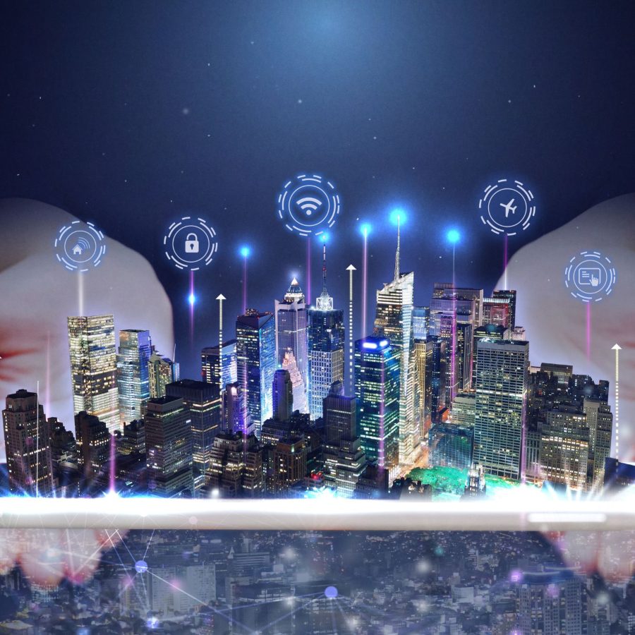 A digitally enhanced image of a futuristic city skyline emerging from a tablet device held in two hands.