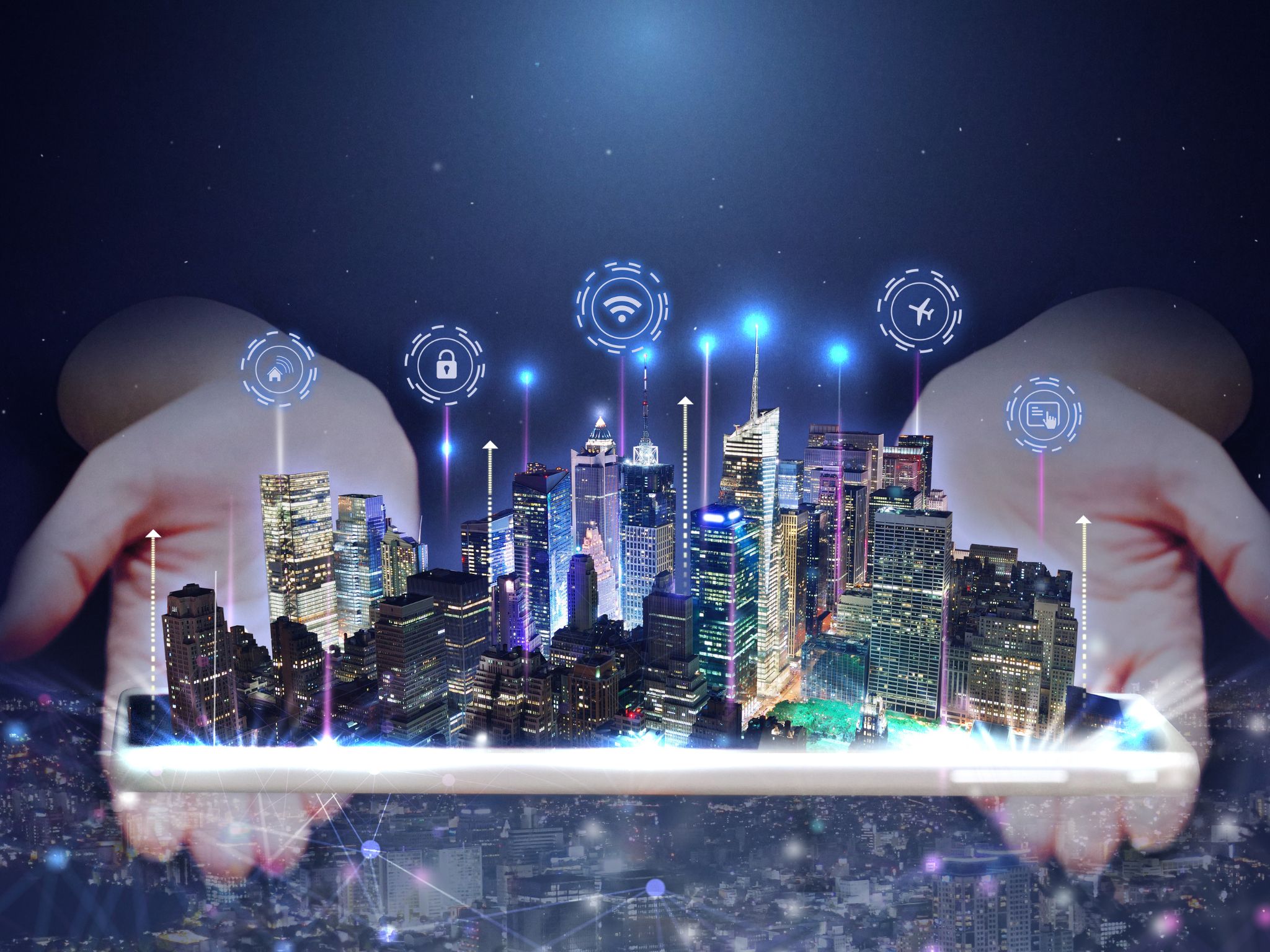 A digitally enhanced image of a futuristic city skyline emerging from a tablet device held in two hands.